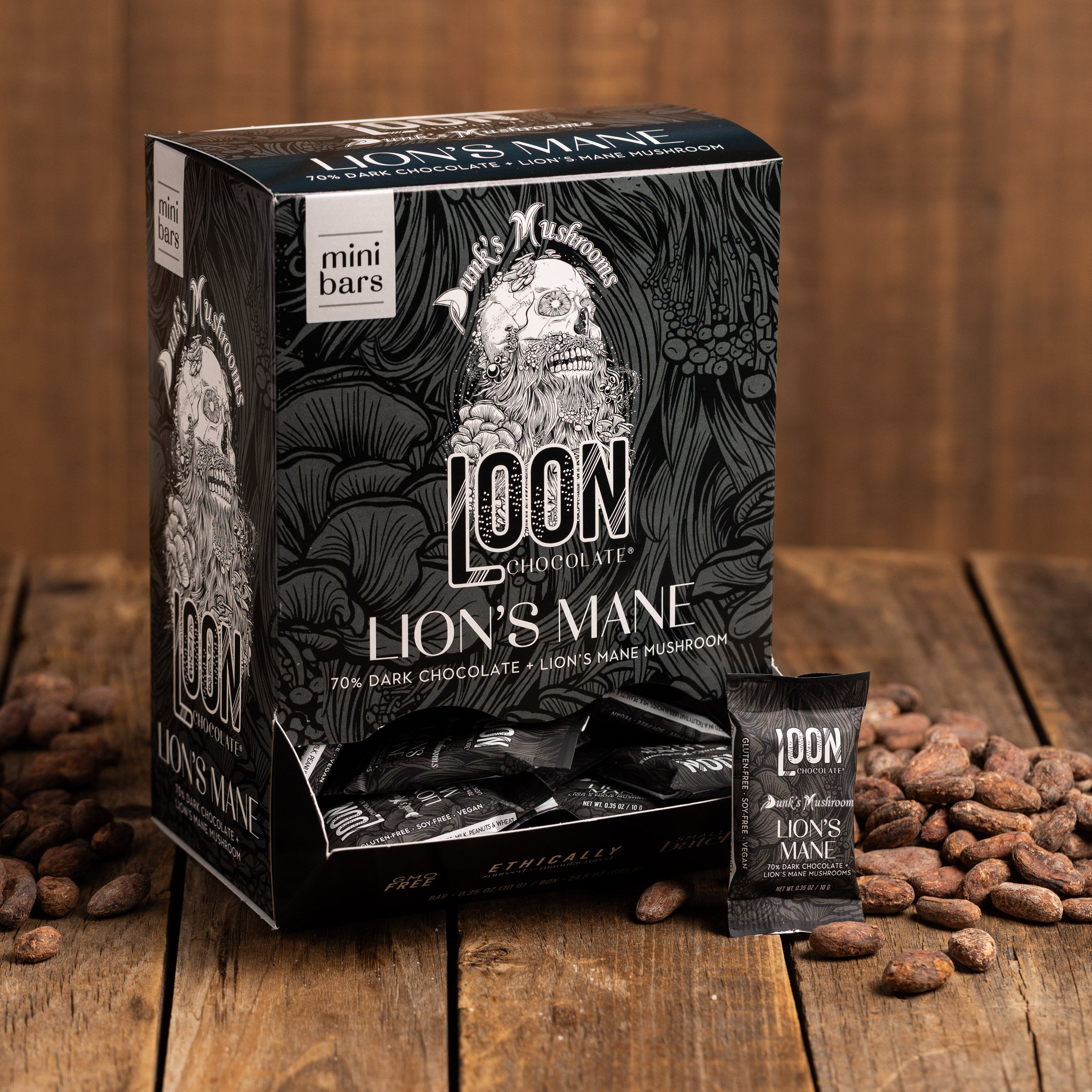 Box of Lion's Mane Dark Chocolate mini bars by Loon Chocolate on wooden surface with cacao beans
